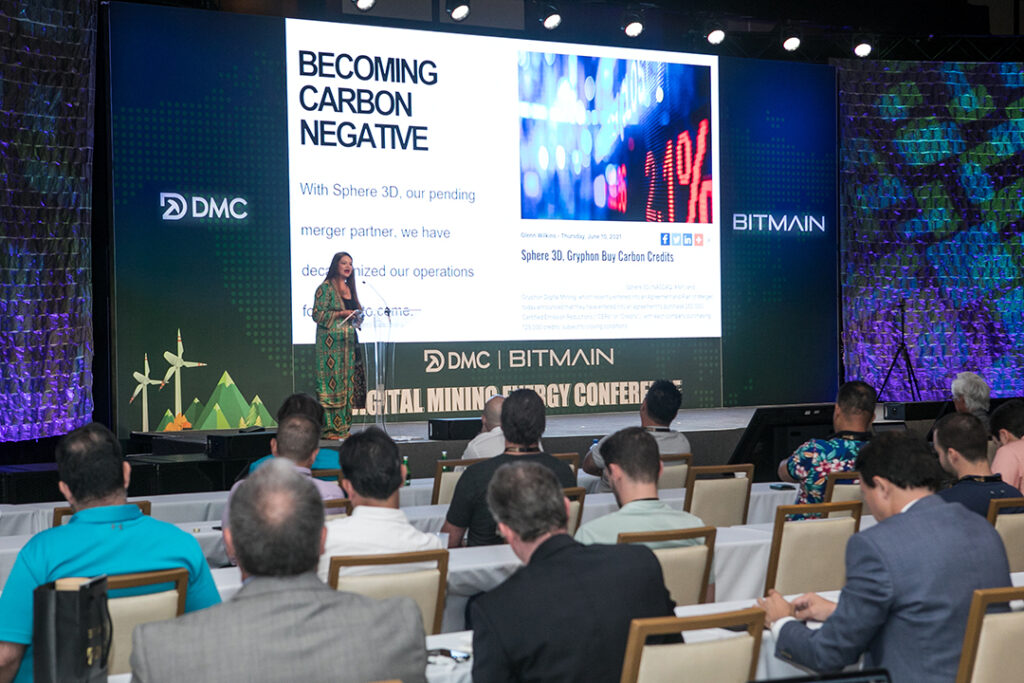 Woman speaking on stage in front of audience